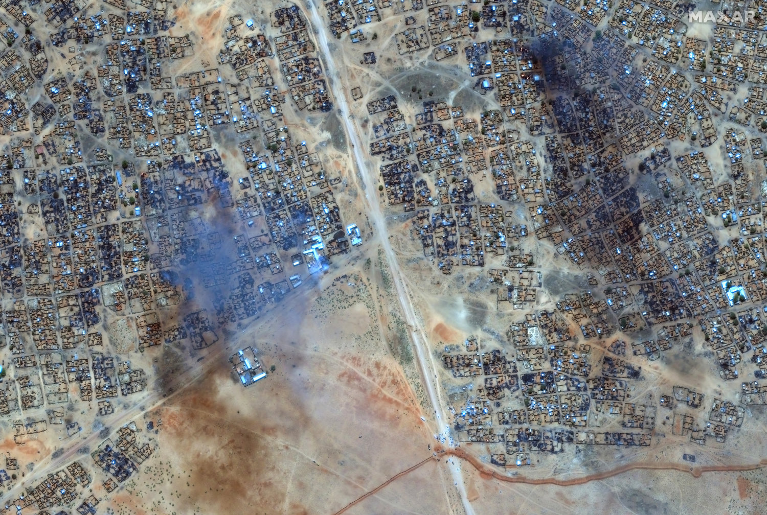 This handout image courtesy of Maxar Technologies taken on April 16, 2025 shows fire and smoke at Zamzam camp near the besieged Darfur city of El-Fasher. (Maxar Technologies via AFP)