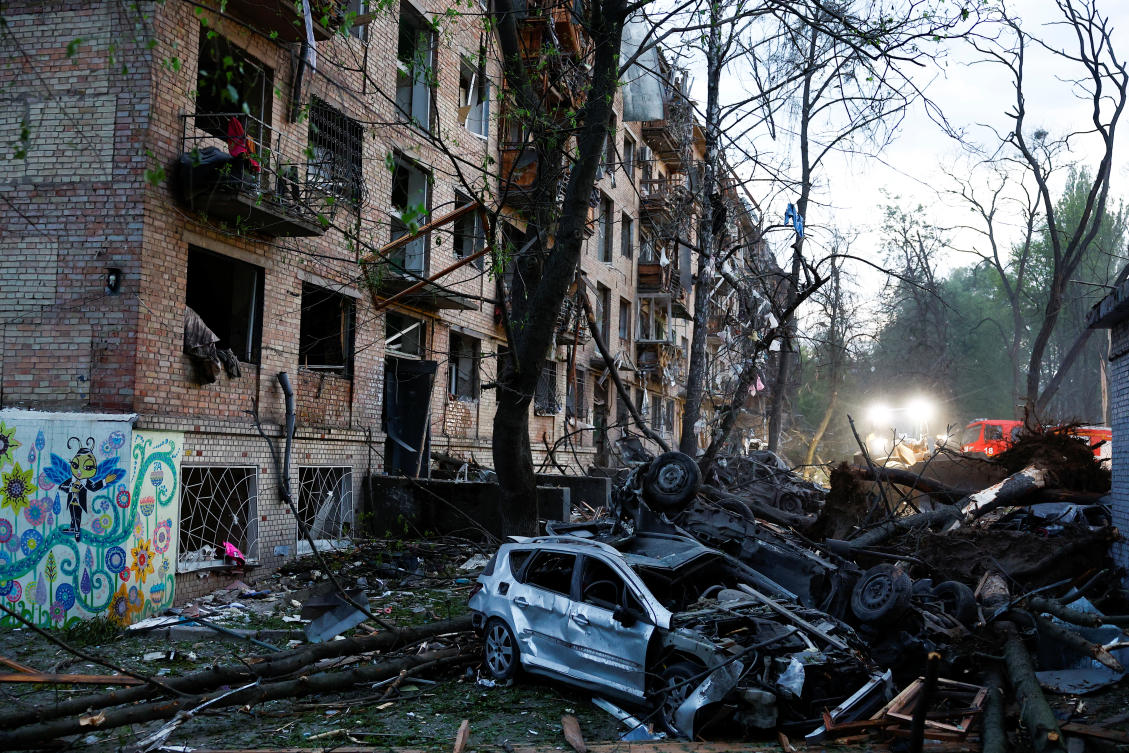 Damaged vehicles lie at the site of a Russian ballistic missile strike in Kyiv, Apr. 24, 2025. (Reuters)