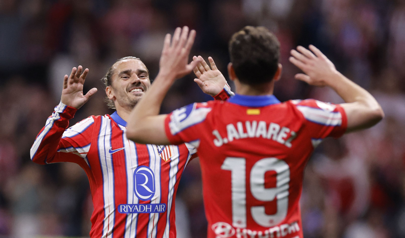 Atletico Madrid's Argentine forward #19 Julian Alvarez celebrates with Atletico Madrid's French forward #07 Antoine Griezmann scoring his team's third goal during the Spanish league football match between Club Atletico de Madrid and Rayo Vallecano de Madrid at the Metropolitano Stadium in Madrid, on April 24, 2025. (AFP)