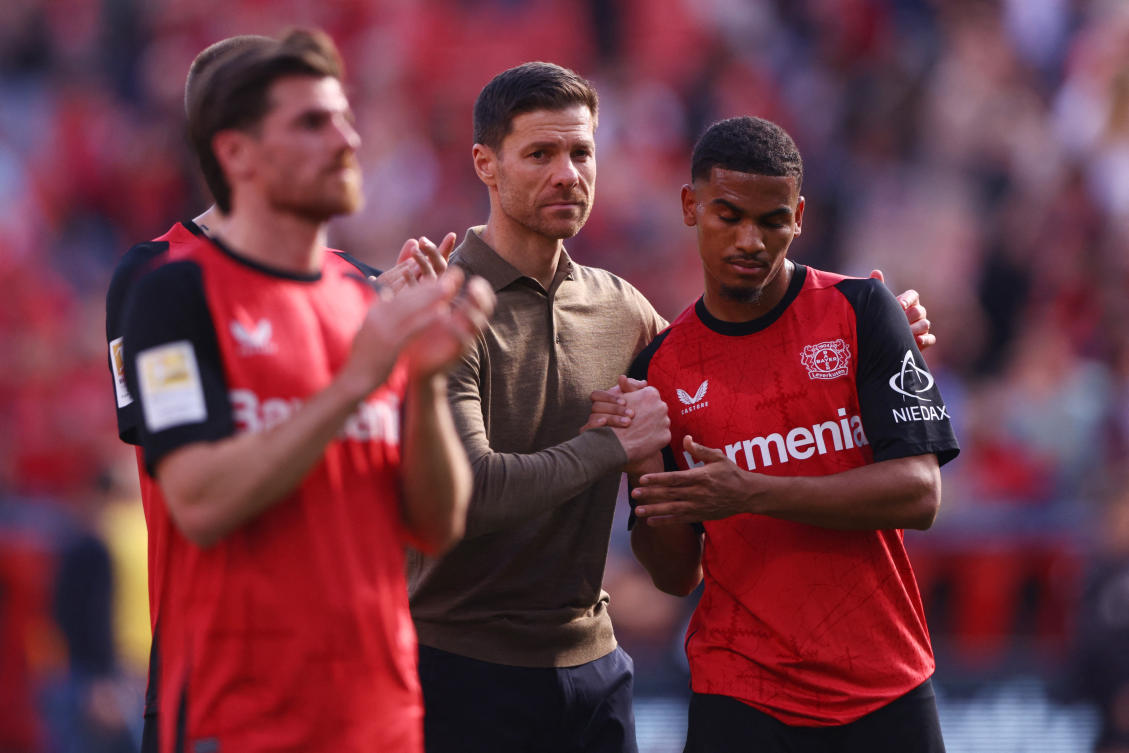Bayer Leverkusen coach Xabi Alonso and Amine Adli after their Bundesliga match against FC Augsburg — BayArena, Leverkusen, Apr. 26, 2025. (Reuters)