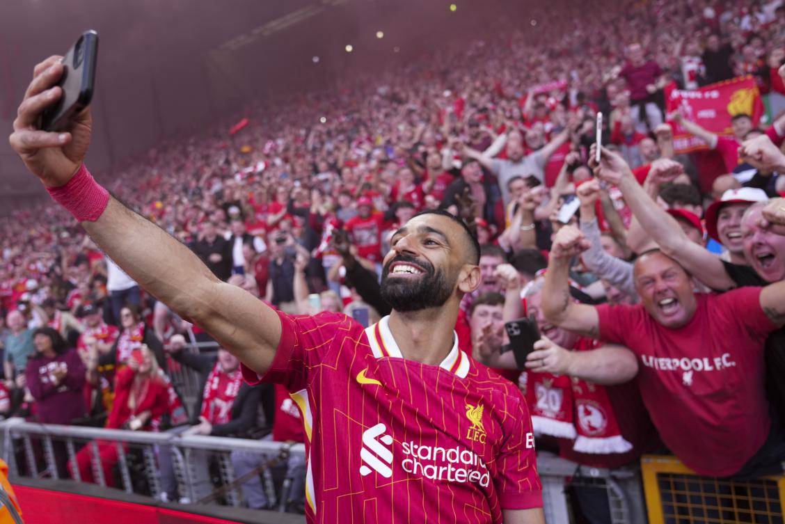 Liverpool’s Mohamed Salah celebrates by taking a selfie after winning the English Premier League soccer match between Liverpool and Tottenham Hotspur and clinching the Premier League title at Anfield in Liverpool, England, Sunday, April 27, 2025. (AP)