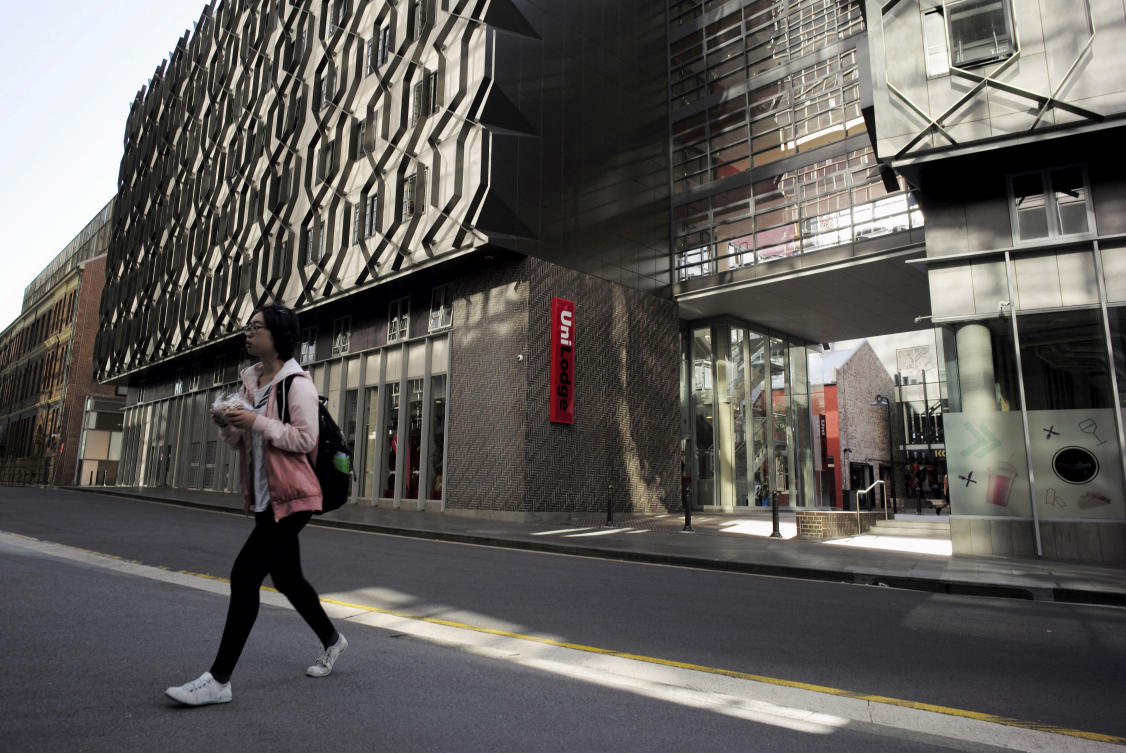 Above, a student walks from high density housing near the campus of the University of Technology in Sydney. There were more than a million international students enrolled in Australia in 2024, while 572,000 students commenced their studies. (Reuters)