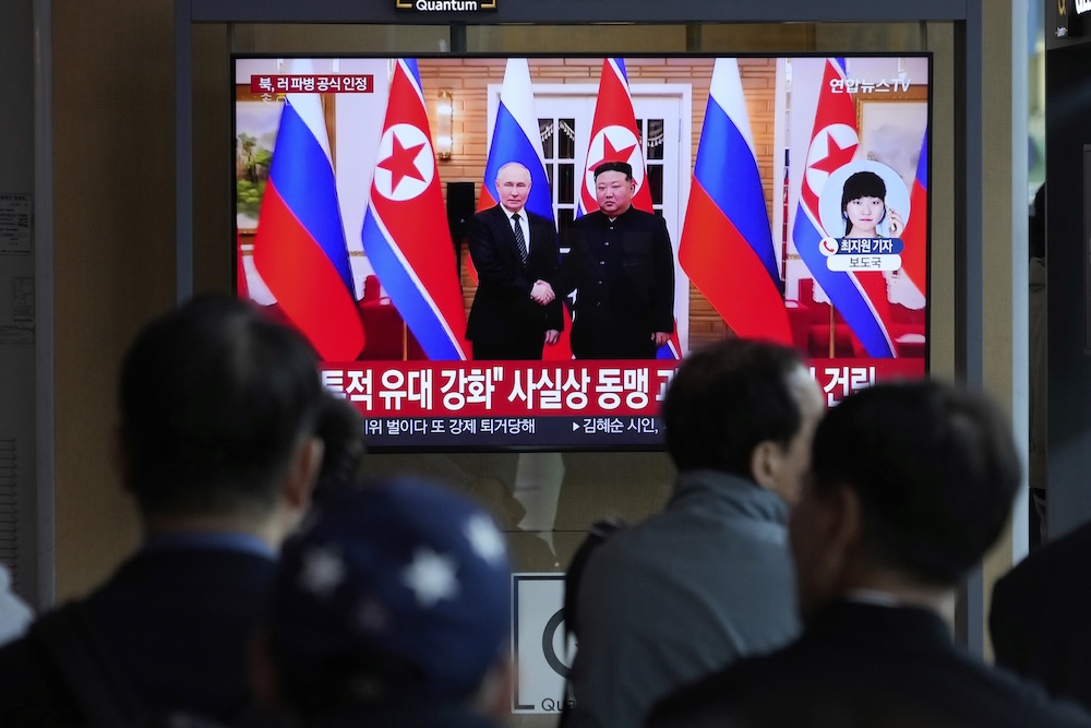 A TV screen shows a file image of North Korean leader Kim Jong Un and Russian President Vladimir Putin in Pyongyang, during a news program at the Seoul Railway Station in Seoul on April 28, 2025. (AP)