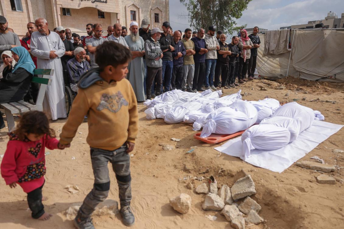 Palestinians pray by the bodies of members of the Abou Mahadi family, killed in Israeli strikes on the family home in Beit Lahia in the northern Gaza Strip, Apr. 28, 2025. (AFP)