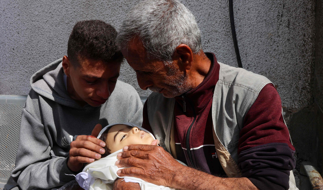 Palestinians mourn the loss of a child at Al-Shifa Hospital on Monday. (AFP)