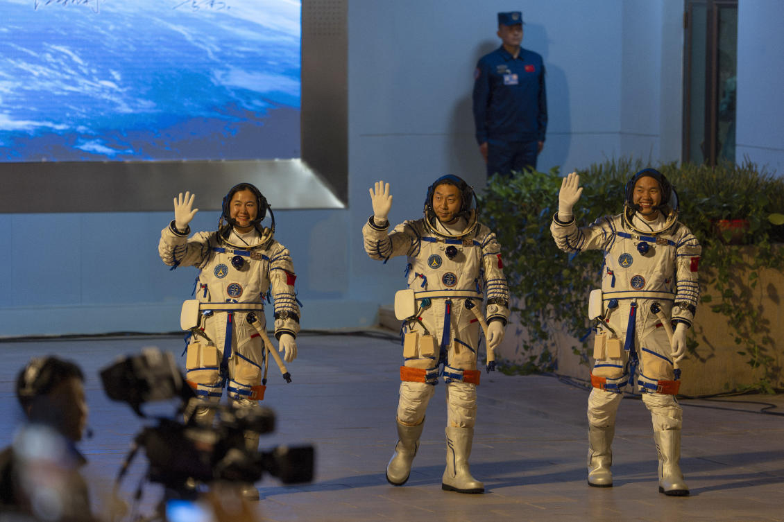 From left: Chinese astronauts Wang Haoze, Cai Xuzhe and Song Lingdong wave as they attend the see-off ceremony for the Shenzhou-19 mission at the Jiuquan Satellite Launch Center in northwestern China on Oct. 30, 2024. (AP)