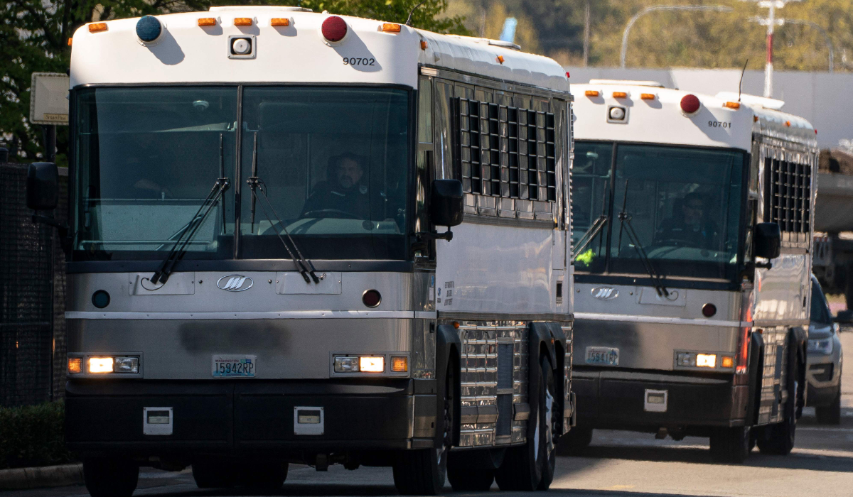 Buses operated by the GEO Group depart from King County International Airport after transferring detainees to and from a plane chartered by U.S. Immigration and Customs Enforcement (ICE) on April 15, 2025 in Seattle, Washington. (AFP)