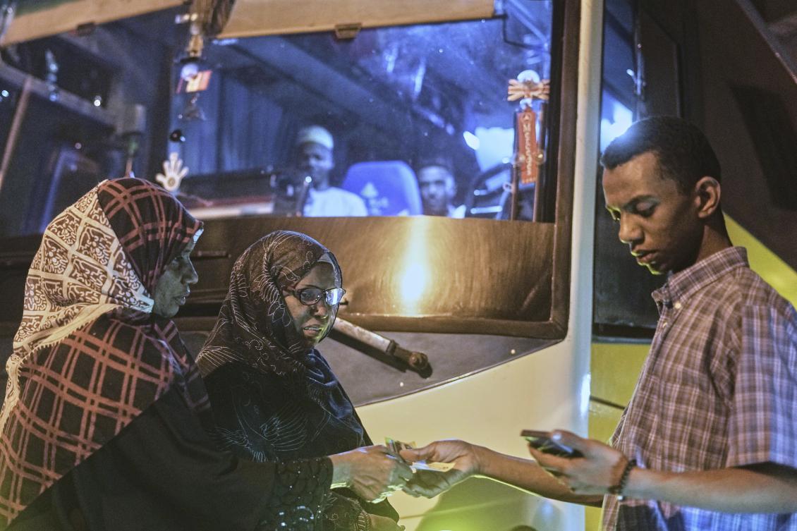 Sudanese women, who were driven from their homes and are now returning, prepare to board a bus at a station in Cairo, Egypt on April 25, 2025. (AP)