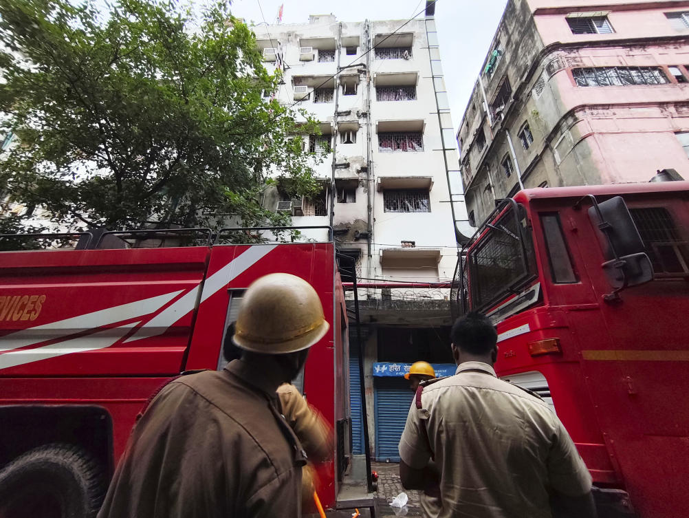 Firefighters inspect a hotel building which caught fire on Tuesday resulting in several deaths, in Kolkata, India, Wednesday, April 30, 2025. (AP Photo/Bikas Das)