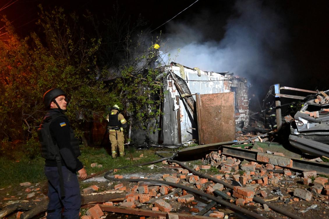 Ukrainian rescuers work at the site of a drone attack in Kharkiv late on April 29, 2025, amid the Russian invasion of Ukraine. (File/AFP)