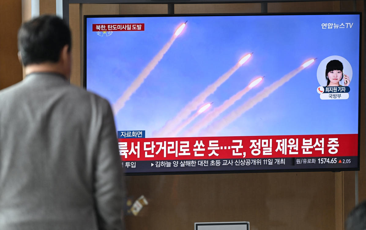 A man watches a television screen showing a news broadcast with file footage of a North Korean missile test. (File/AFP)