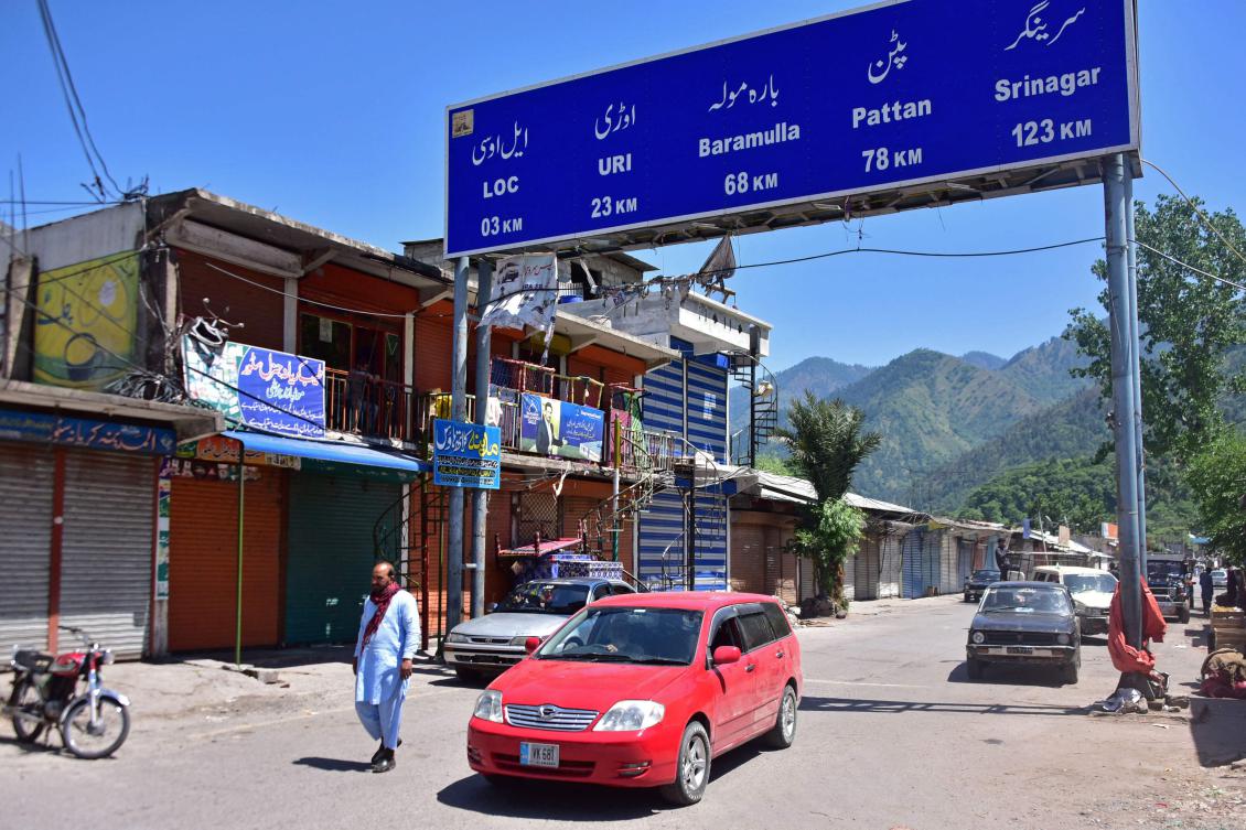 Commuters driving past closed shops at a bazaar in the Chakothi village of Pakistan-administered Kashmir, about 3kms from the Line of Control, Apr. 27, 2025. (AFP)