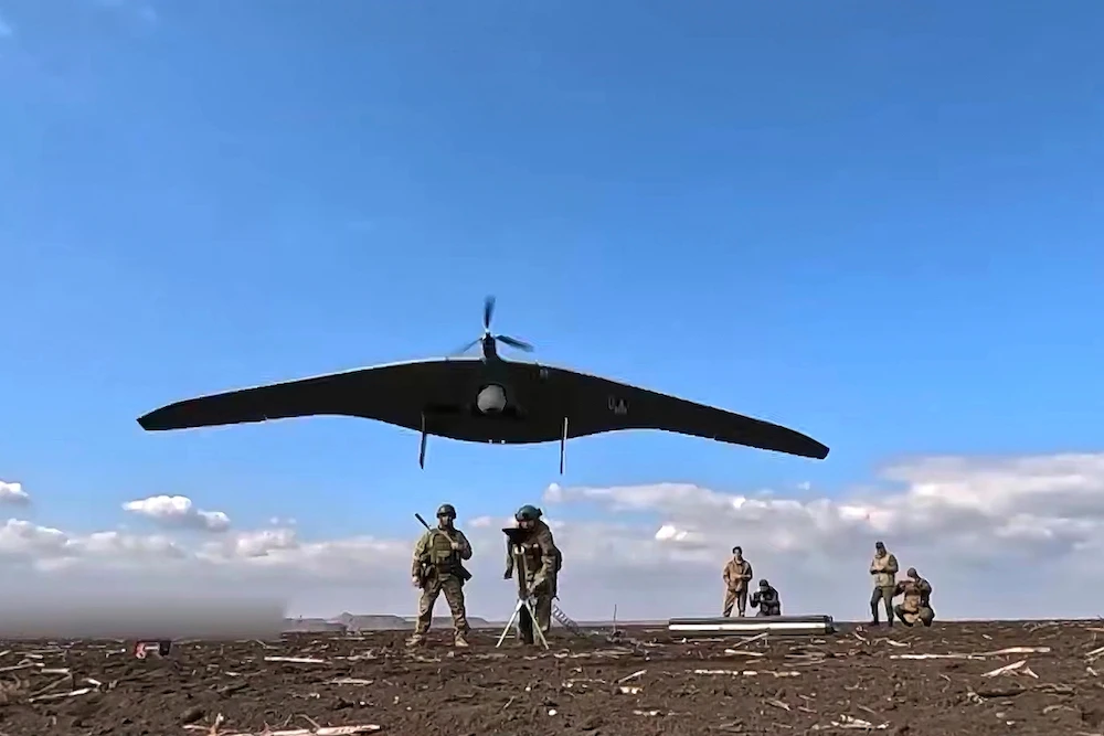 Russian soldiers launch a Supercam intelligence unmanned aerial vehicle towards Ukrainian positions. (AP)