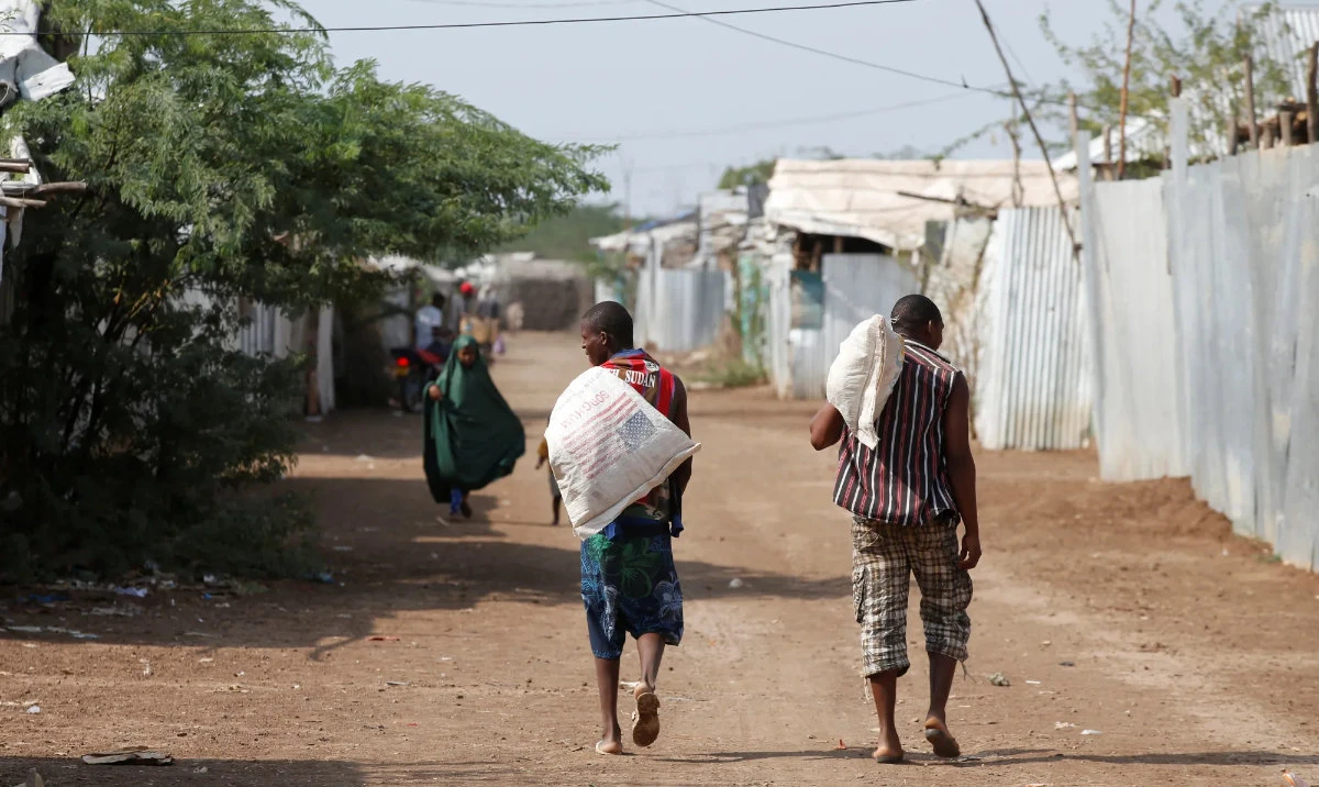 Men carry bags of food aid at the Kakuma refugee camp in northern Kenya. (Reuters/File)