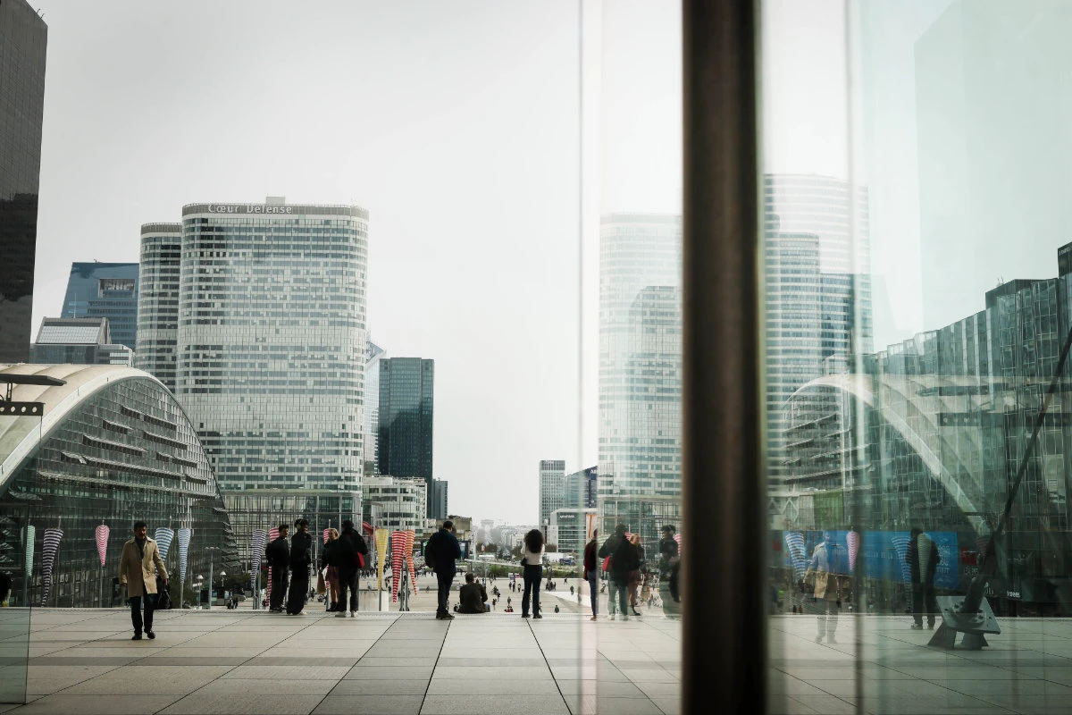 People stroll on March 21, 2025 in La Defense business district outside Paris. (AP Photo/file)