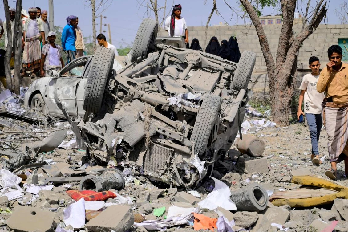 People assess the damage following reported overnight strikes that Huthi rebels said hit the Water Management building in Mansouriya in Yemen's Hodeida governorate, Apr. 2, 2025. (AFP)