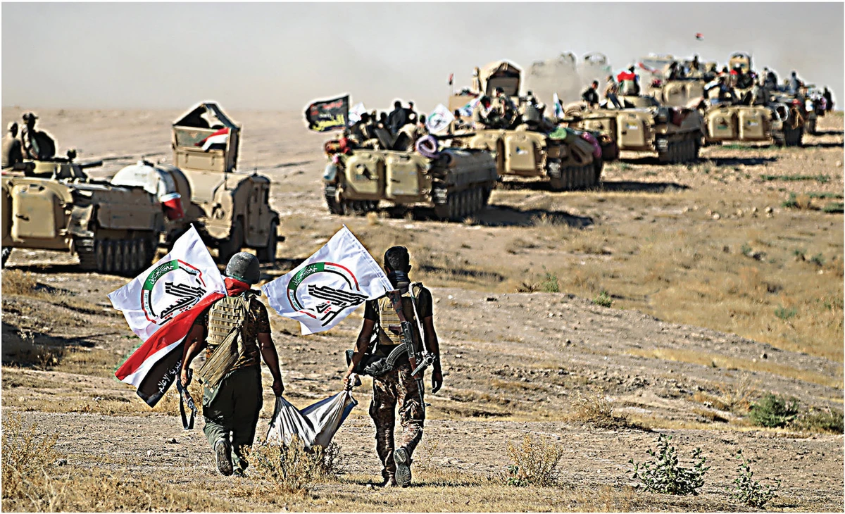 This photo taken on August 22, 2017, shows Hashed Al-Shaabi fighters advancing towards the town of Tal Afar, west of Mosul, as part of the Iraqi government counteroffensive against Daesh terrorists. (AFP/File)