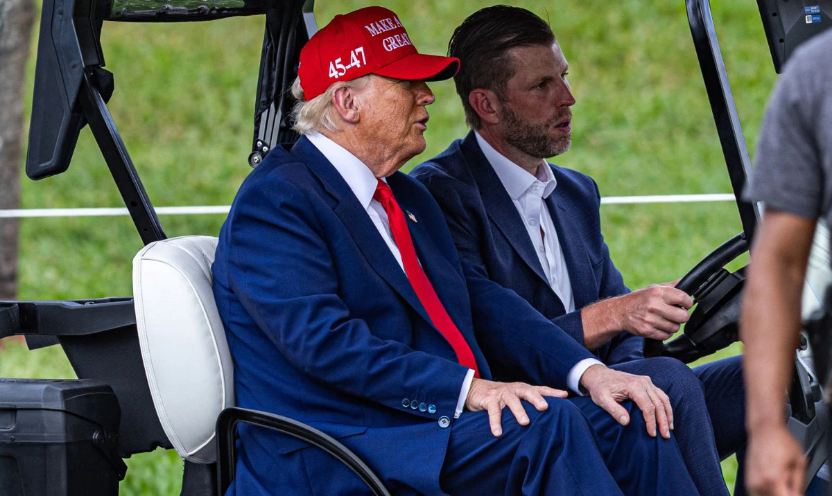 US President Donald Trump and his son Eric Trump drive in a golf cart after arriving in Marine One on the ninth hole during previews for LIV Golf Miami at Trump National Doral Miami on Thursday in Doral, Florida. (AFP)