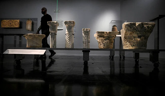 A man walks among the antiques during the installation of the archaeological heritage exhibition “Treasures saved from Gaza — 5000 years of history” (Tresors sauves de Gaza — 5000 ans d’histoire) at the Institut du Monde Arabe, in Paris on March 31, 2025. (AFP)