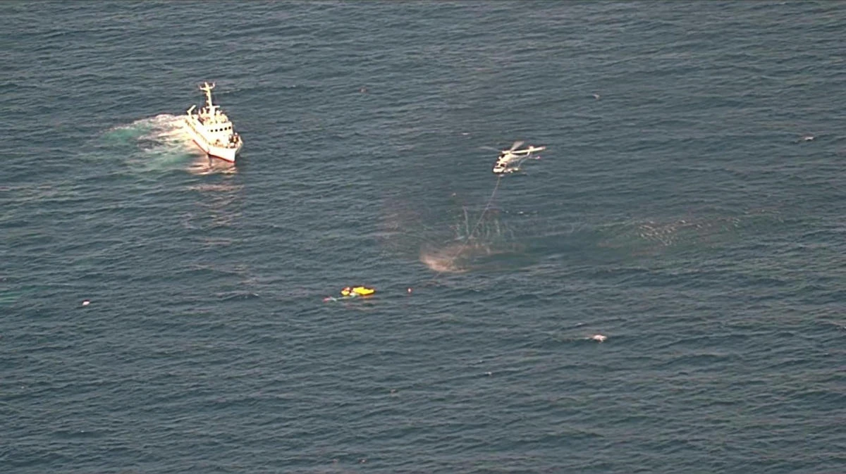 A coast guard vessel and a helicopter conduct a rescue operation after a medical transport helicopter fell into the sea in southwestern Japan on April 6, 2025. (The 7th Regional Japan Coast Guard Headquarters via AP)