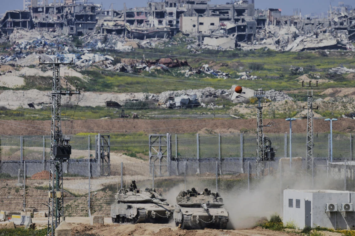 Above, Israeli tanks maneuver along the border with north of the Gaza Strip on March 18, 2025. Israel has depicted its tightening grip on Gaza as a temporary necessity to pressure Hamas into releasing the remaining hostages taken during the Oct. 7, 2023 attack. (AP)