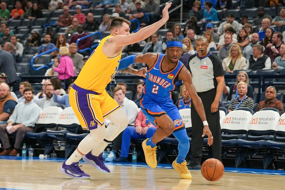 Oklahoma City Thunder guard Shai Gilgeous-Alexander drives past Los Angeles Lakers guard Luka Doncic during the second half of an NBA basketball game Tuesday in Oklahoma City. (AP)