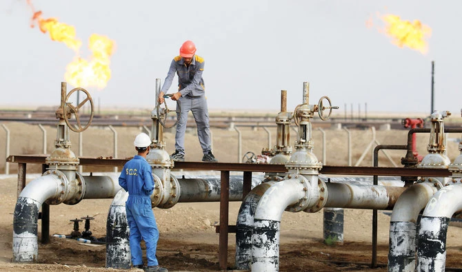 Iraqi laborers work at an oil refinery in the southern town Nassiriya. (AFP/File)