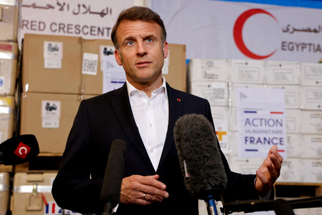 France’s President Emmanuel Macron speaks in front of humanitarian aid destined to Gaza, at the Egyptian Red Crescent warehouse in Arish, Egypt, April 8, 2025. (Reuters)
