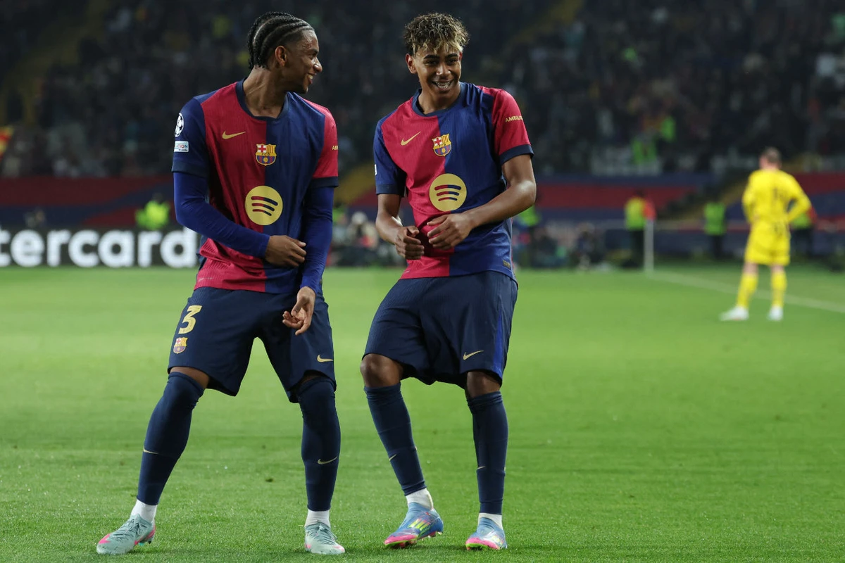 Barcelona's Spanish forward #19 Lamine Yamal celebrates with Barcelona's Spanish defender #03 Alex Balde (L) scoring his team's fourth goal during the UEFA Champions League Quarter final First Leg football match between FC Barcelona and BVB Borussia Dortmund at the Estadi Olimpic Lluis Companys in Barcelona on April 9, 2025. (AFP)