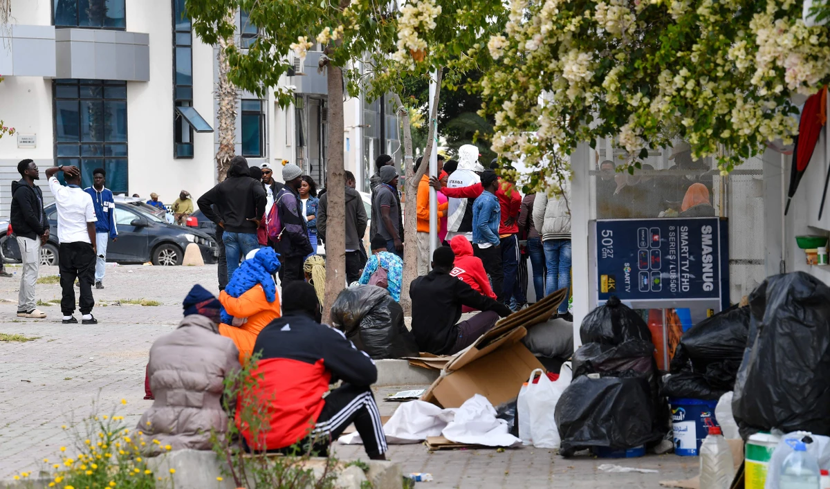 Migrants from sub-Saharan Africa wait in front of the International Organization for Migration’s headquarters in Tunis on Thursday. (AFP)