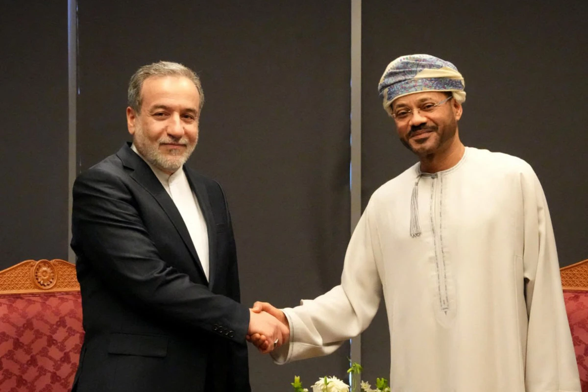 Iran's Foreign Minister Abbas Araghchi (L) meets with Oman's Foreign Minister Sayyid Badr al-Busaidi in Muscat on April 12, 2025, ahead of the first meeting between Iranian and US delegations to lay the groundwork for new deal on Iran's nuclear program. (Iran handout photo via AFP)