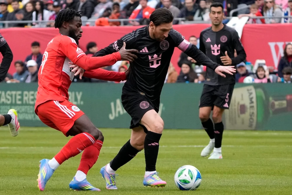 Chicago Fire forward Jonathan Bamba, left, defends Inter Miami forward Lionel Messi during the second half of an MLS football game Sunday in Chicago. (AP)
