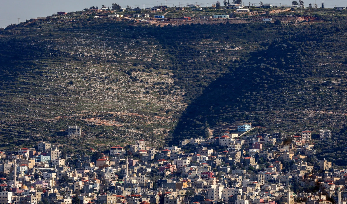 This picture taken from Nablus on March 23, 2025 shows southeast of the city the new expansion of the Israeli settlement outpost of Itamar, on the hill overlooking the village of Beit Furik in the occupied West Bank. (AFP)