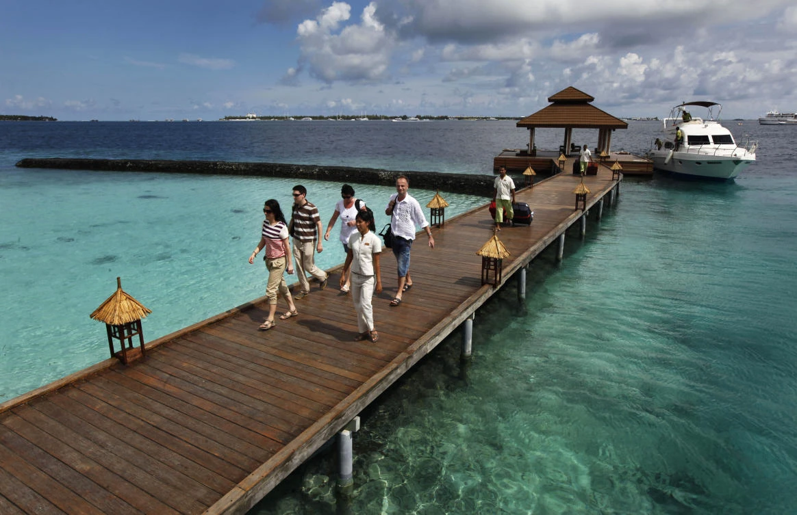 Foreign tourists arrive in a resort in the Kurumba island in Maldives. (File/AP)