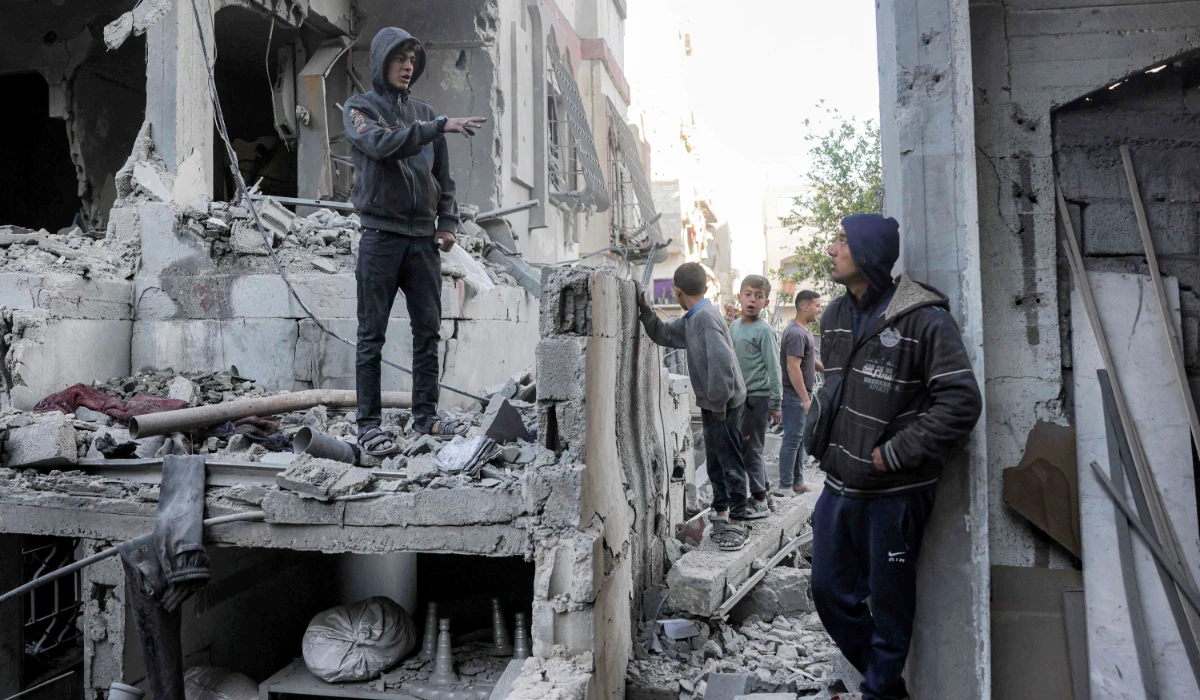 Boys inspect the rubble of a destroyed building that was hit by Israeli bombardment in Jabalia in the northern Gaza Strip on Friday. (AFP)