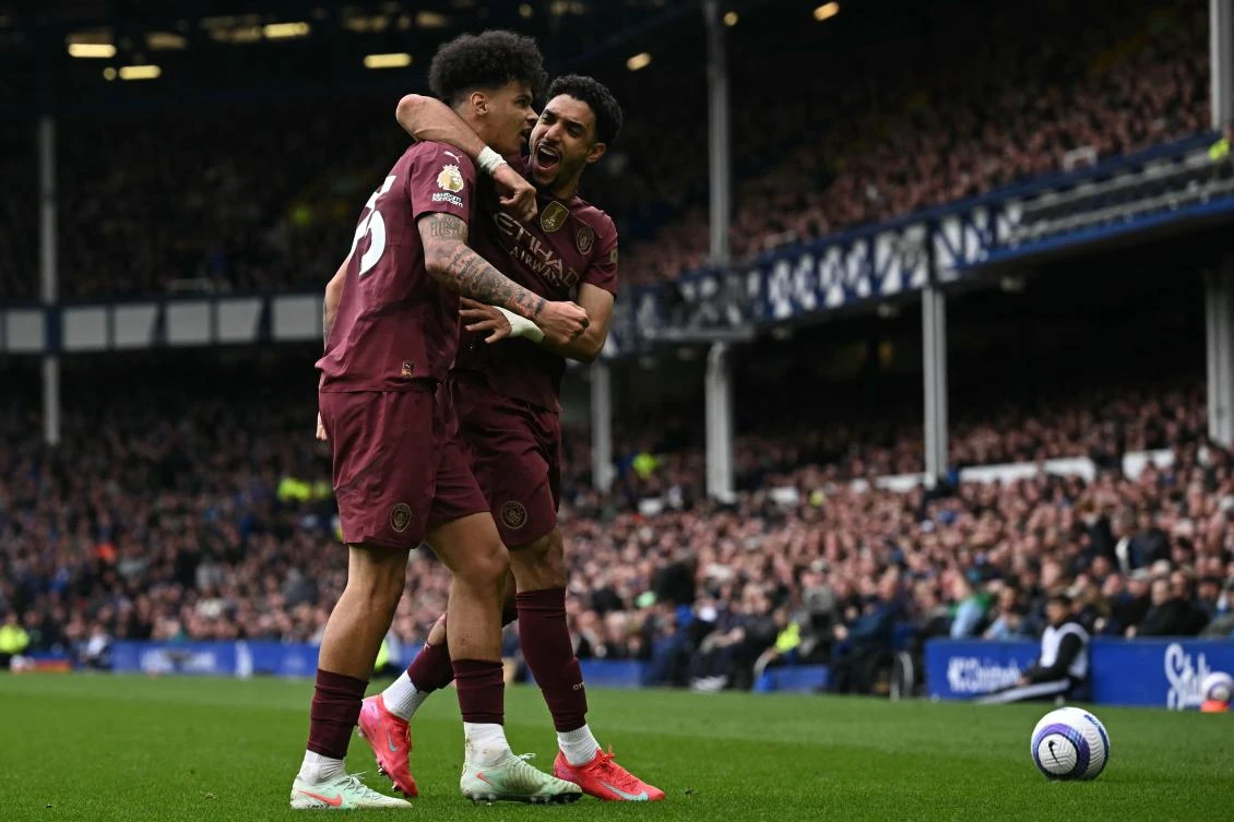 Manchester City’s English midfielder Nico O’Reilly celebrates with Egyptian striker Omar Marmoush after scoring the opening goal during their EPL match against Everton at Goodison Park in Liverpool, on Apr. 19, 2025. (AFP)