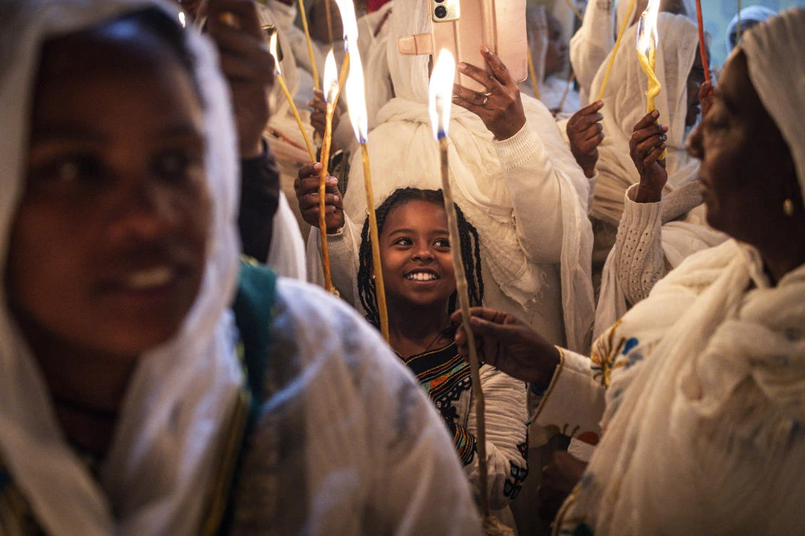 Ethiopian Orthodox Christian pilgrims light candles during the ceremony of the "Holy Fire" at the Deir Al-Sultan Monastery (AFP)