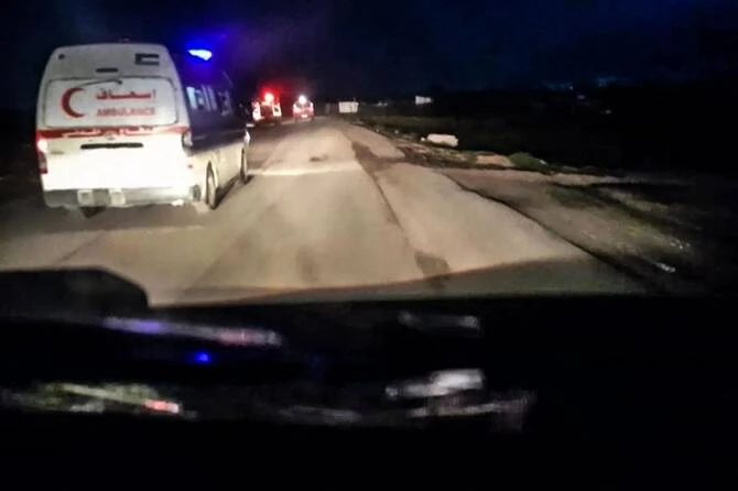 This image grab from a handout video reportedly recovered from the cellphone of an aid worker killed in Gaza alongside other rescuers and released by the Palestine Red Crescent Society (PRCS)on April 5, 2025, shows a Red Crescent ambulance with its emergency lights flashing as it drives toward a fire truck and other ambulances in Rafah in the northern Gaza Strip, according to the PRCS. (AFP)
