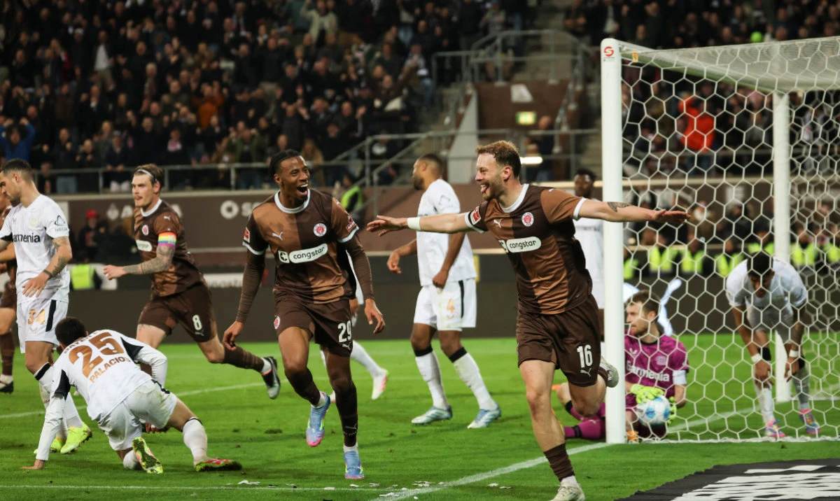 St. Pauli's Carlo Boukhalfa, right, celebrates during the Bundesliga soccer match between FC St. Pauli and Bayer Leverkusen at Millerntor-Stadion, Hamburg, Germany, Sunday April 20, 2025. (AP)