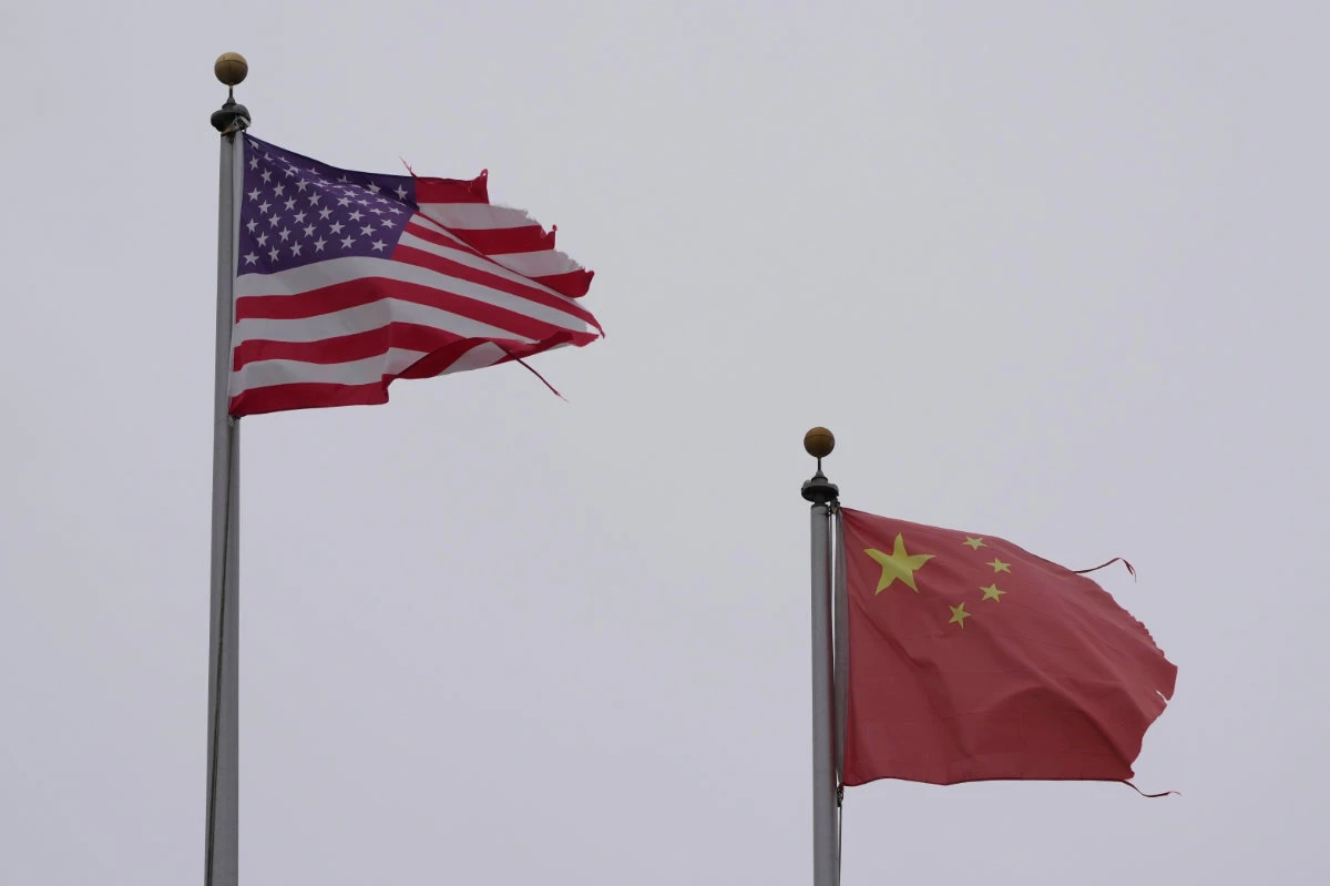 A flag of the United States flies next to a flag of China in Chinatown, San Francisco, on April 18, 2025. (AP Photo)