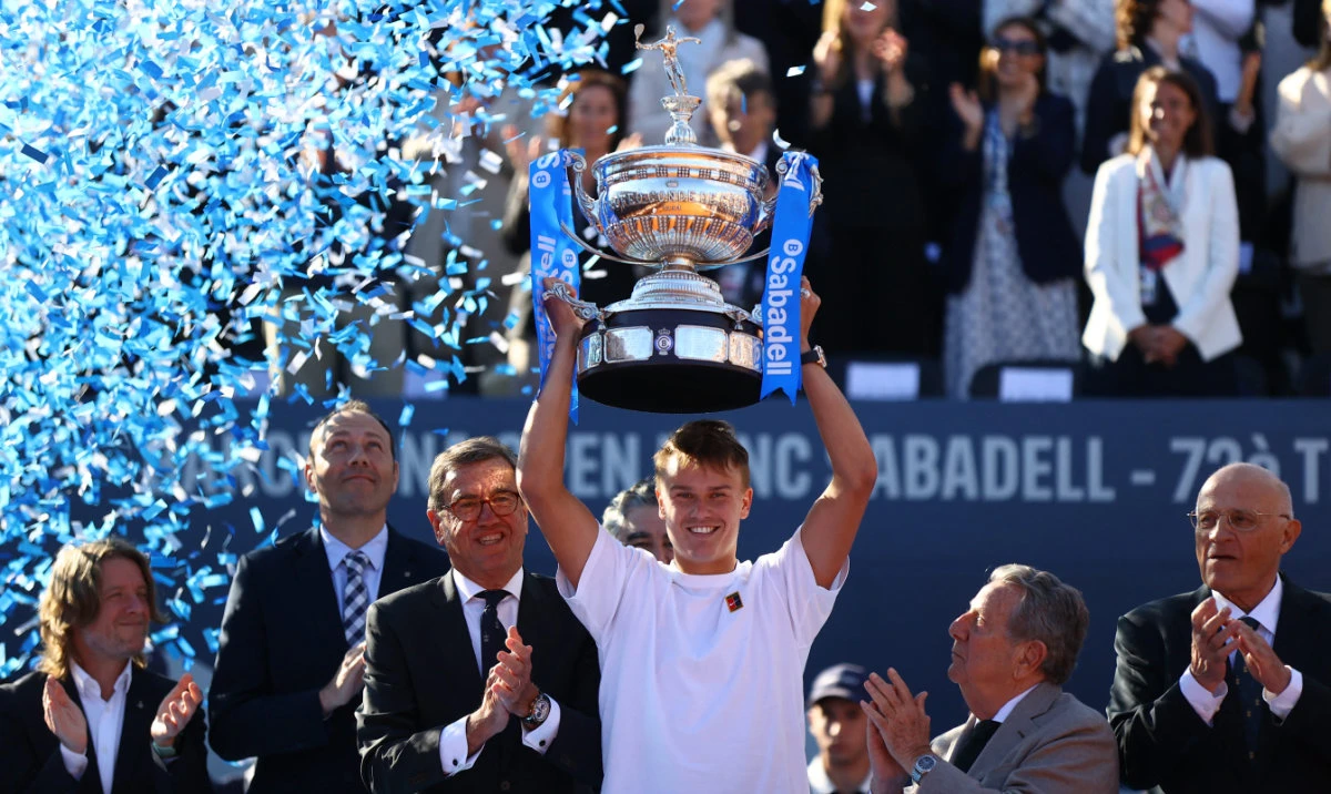 Denmark's Holger Rune celebrates with the trophy on the podium after winning the Barcelona Open final against Spain's Carlos Alcaraz Sunday. (Reuters)