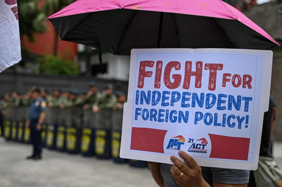 A protester holds up a sign and shouts slogans during a protest against the Balikatan joint military exercises between the Philippines and the US in Quezon City on April 21, 2025. (AFP)