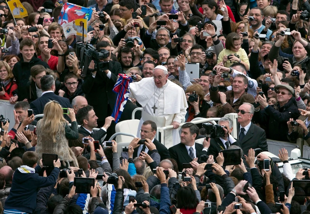 Pope Francis holds a San Lorenzo football jersey after celebrating his first Easter Mass in St. Peter’s Square at the Vatican on March 31, 2013. (AP file photo)