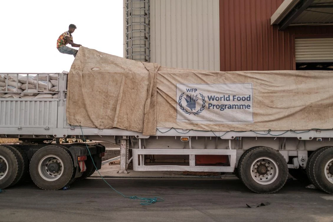 A worker covers a truck full of sacks of grain in a warehouse of the World Food Programme (WFP) in the city of Abala, Ethiopia, on June 09, 2022. (AFP)