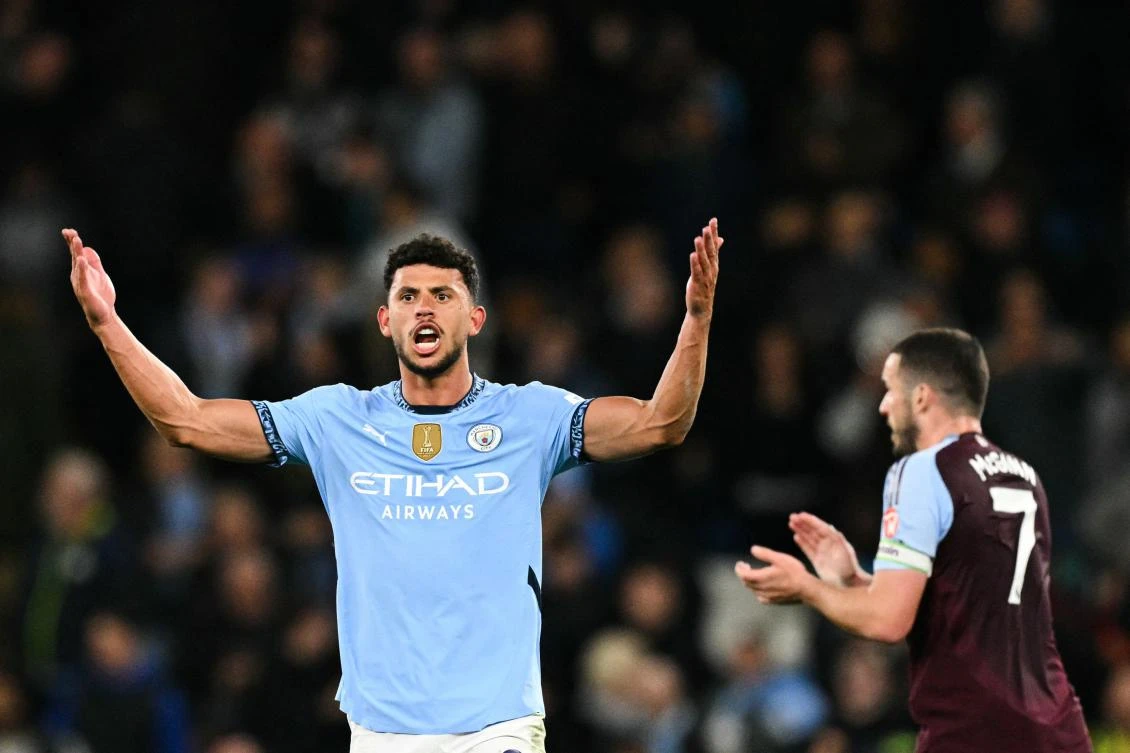 Aston Villa’s Scottish midfielder John McGinn applauds as Manchester City’s Portuguese midfielder Matheus Nunes celebrates after scoring his team’s second goal during their EPL match at the Etihad Stadium in Manchester, on Apr. 22, 2025. (AFP)
