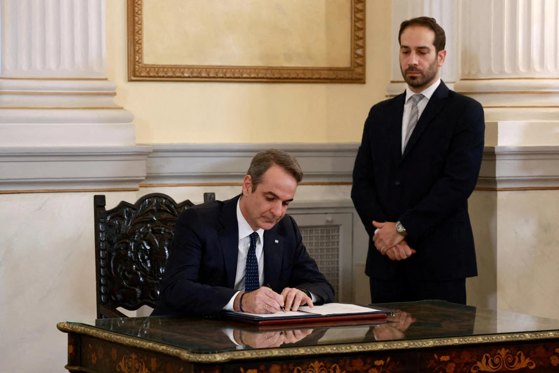 Greek Prime Minister Kyriakos Mitsotakis signs a document during a swearing-in ceremony of the newly appointed members of the government, Mar. 15, 2025. (Reuters)