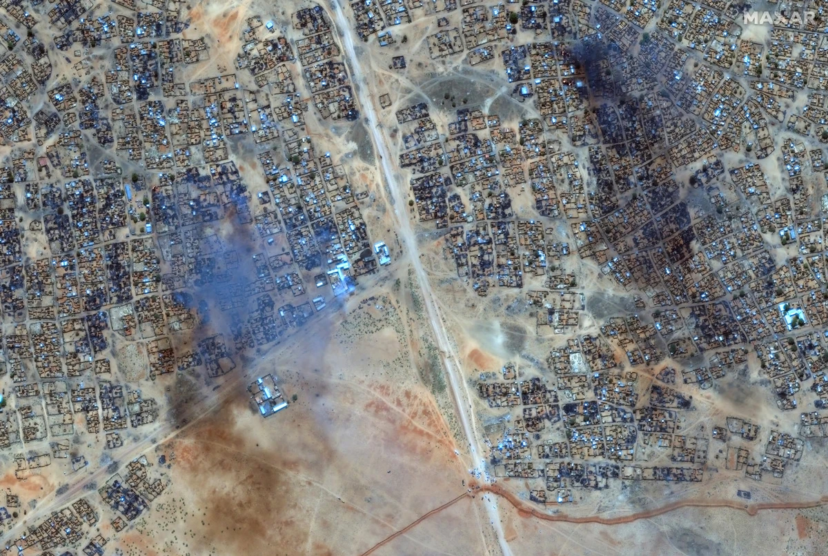 This handout image courtesy of Maxar Technologies taken on April 16, 2025 shows fire and smoke at Zamzam camp near the besieged Darfur city of El-Fasher. (Maxar Technologies via AFP)