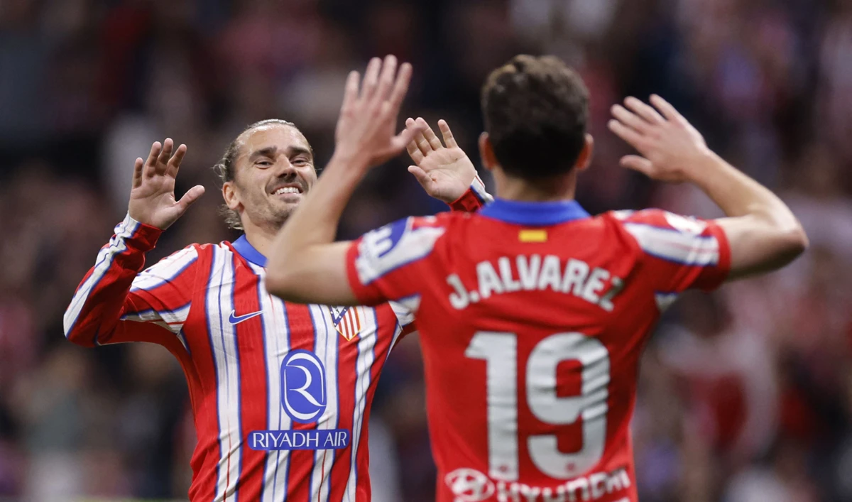 Atletico Madrid's Argentine forward #19 Julian Alvarez celebrates with Atletico Madrid's French forward #07 Antoine Griezmann scoring his team's third goal during the Spanish league football match between Club Atletico de Madrid and Rayo Vallecano de Madrid at the Metropolitano Stadium in Madrid, on April 24, 2025. (AFP)