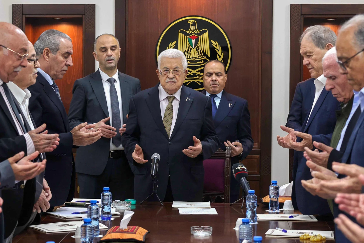 This handout picture released by the Palestinian Authority's Press Office (PPO) shows President Mahmud Abbas (C) leading prayers next to Palestine Liberation Organisation (PLO) Secretary General Hussein al-Sheikh (3rd-L) during a meeting of the organisation's Executive Committee in Ramallah on April 26, 2025. (AFP/Handout/PPO)