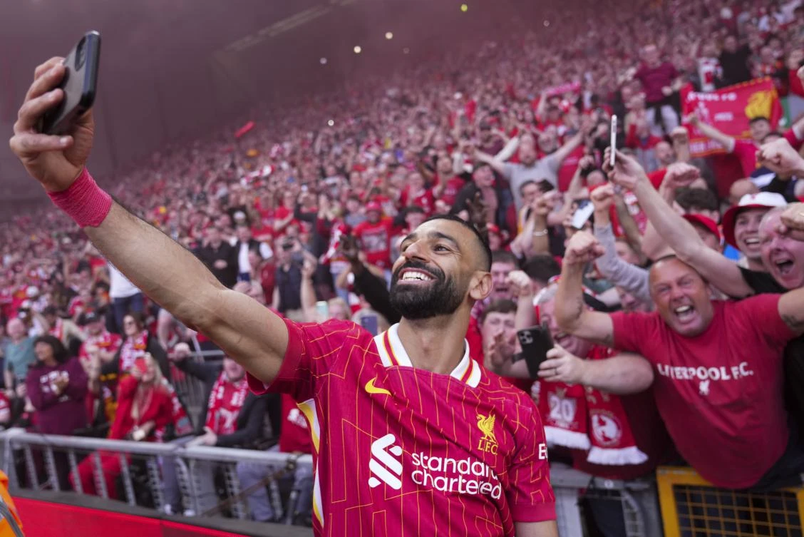 Liverpool’s Mohamed Salah celebrates by taking a selfie after winning the English Premier League soccer match between Liverpool and Tottenham Hotspur and clinching the Premier League title at Anfield in Liverpool, England, Sunday, April 27, 2025. (AP)
